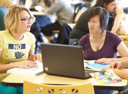Students at a table with a computer