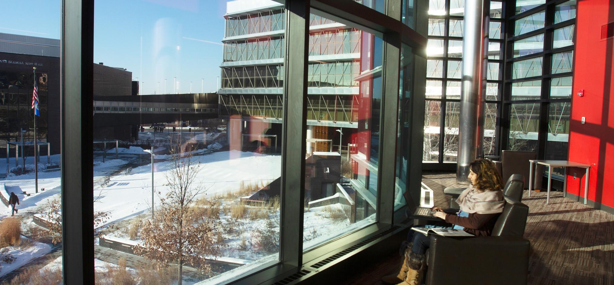 student sitting in Helland Center Lounge
