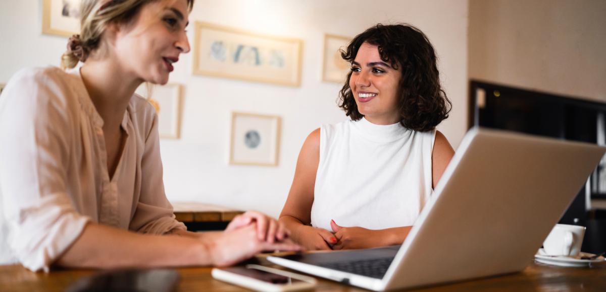 Two women looking at a laptop together 