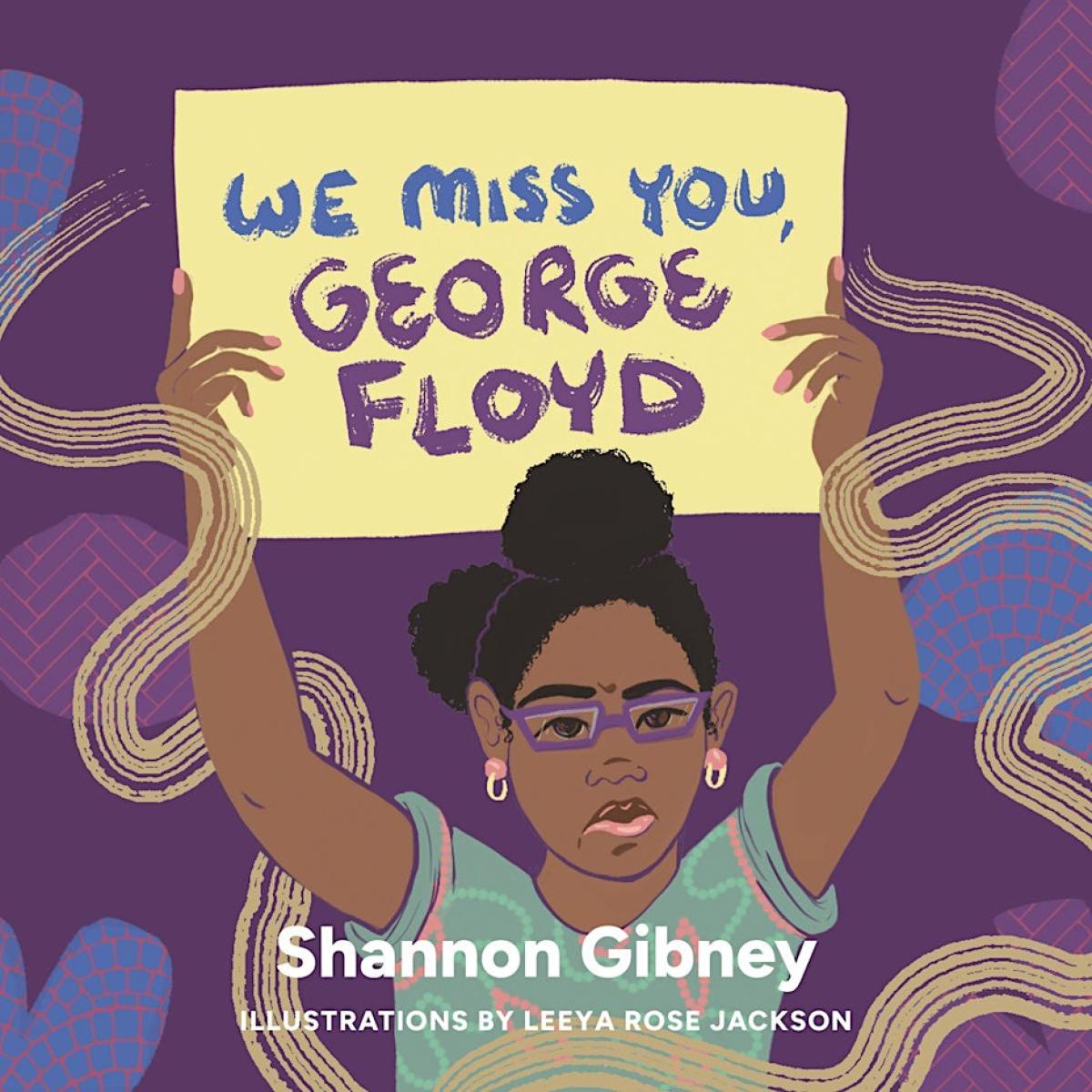 Young girls is holding up a hand-written sign that says "we miss you, George Floyd"