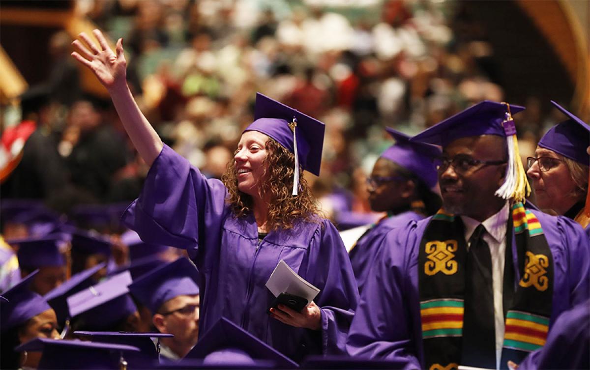 Student Waving to Her Crowd at the Minneapolis College Commencement 2019 student waving to the crowd