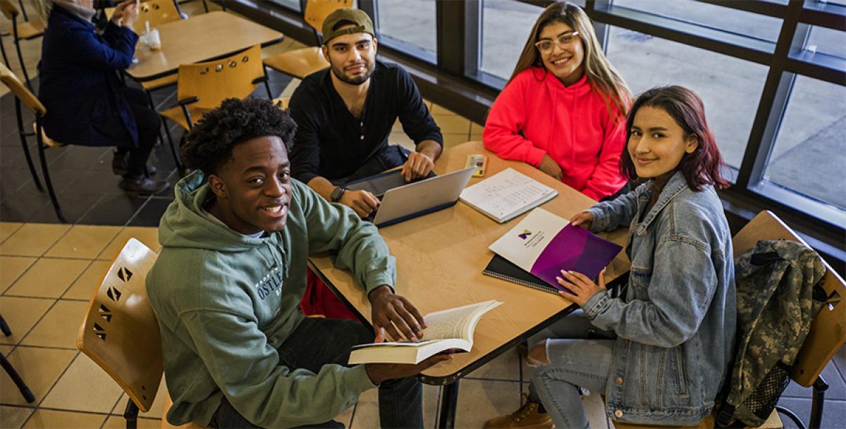 Join the Honors Program at Minneapolis College students at a table