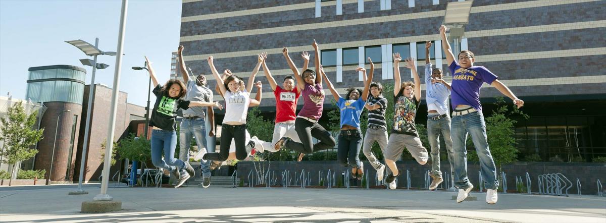 Start College Early at Minneapolis College students jumping in mid-air