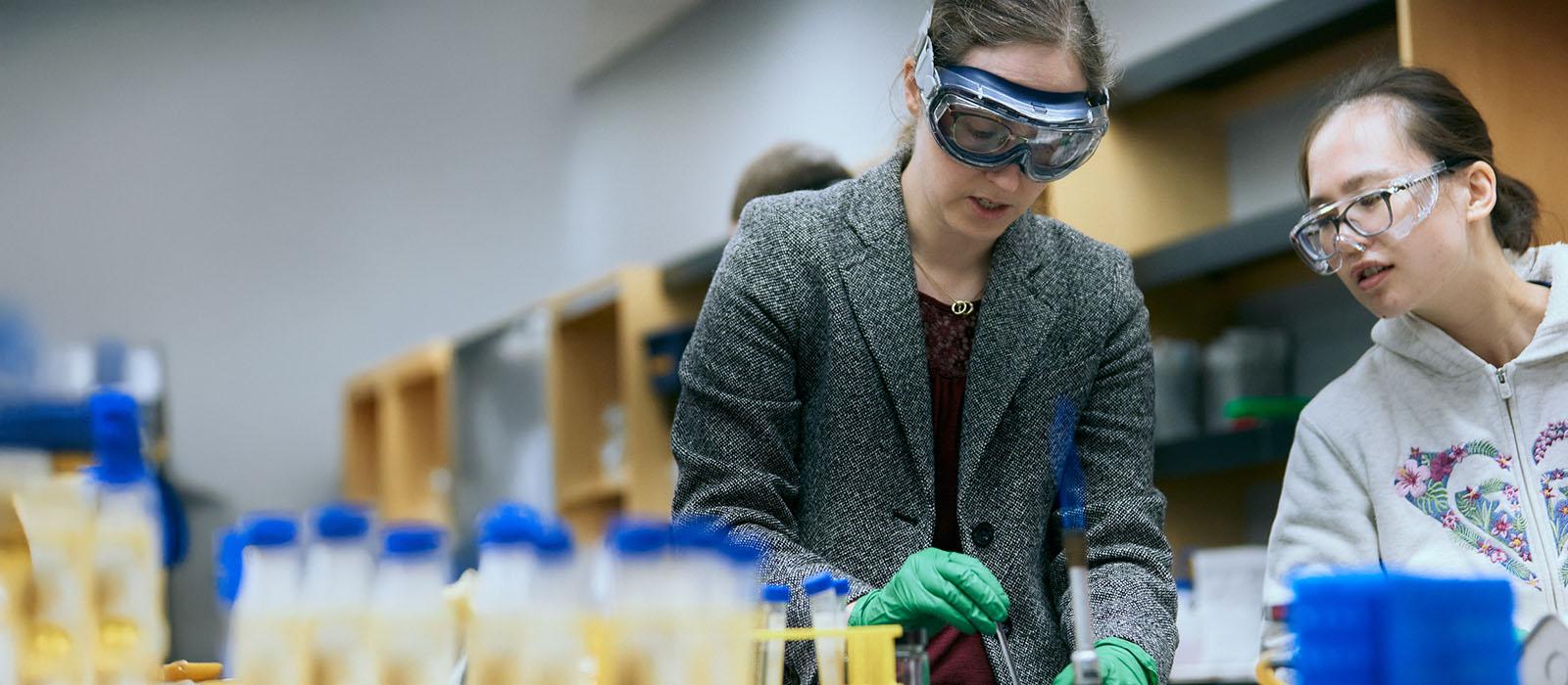An instructor and student work in the science lab.