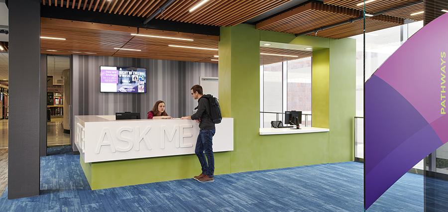 A visitor stops at the Ask Me desk in the skyway over Hennepin Avenue. 