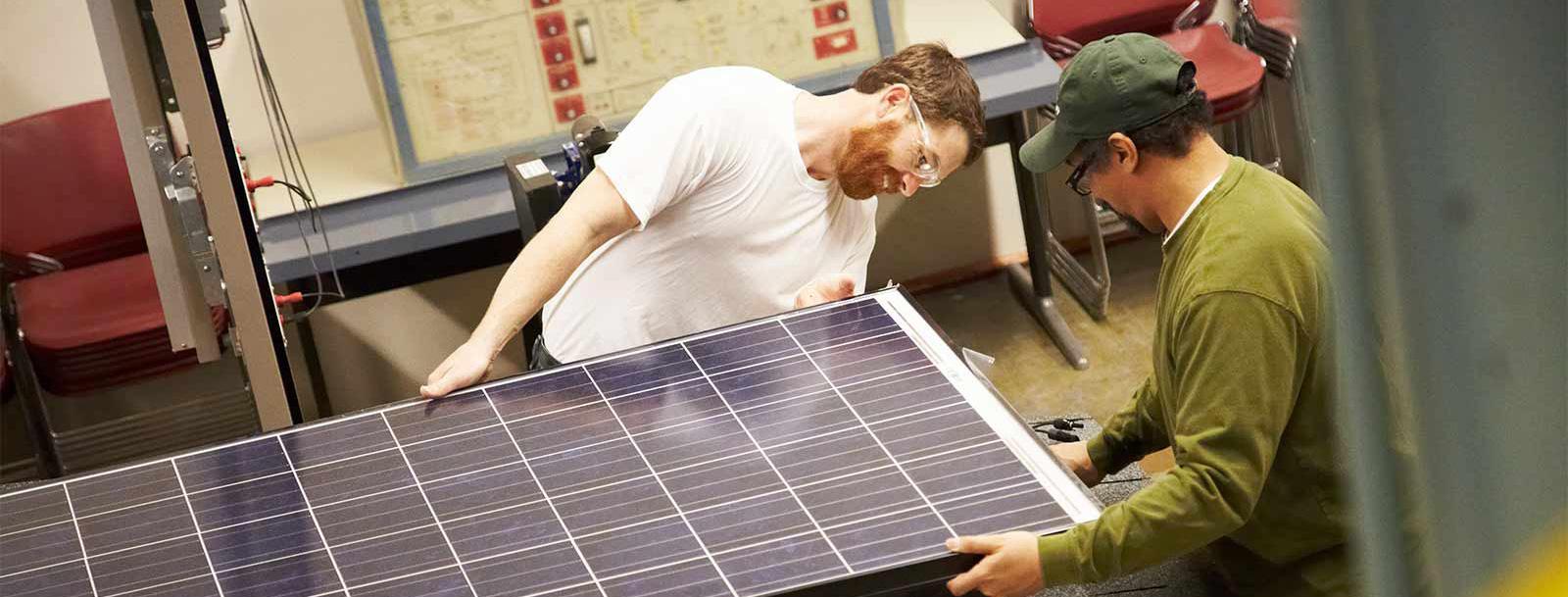 Two workers on a solar panel
