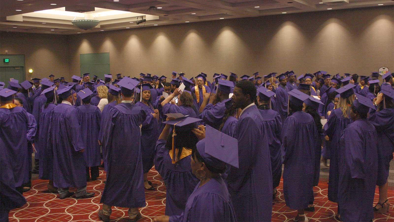 Students with their graduation gowns on waiting to line up and graduate
