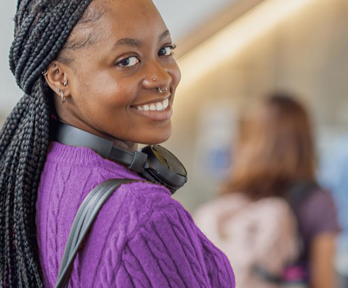 Young woman looking back at person taking photo 