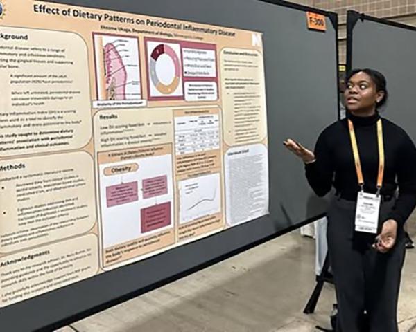 Student stands next to their poster presentation at the ABRCMS 2025 Conference