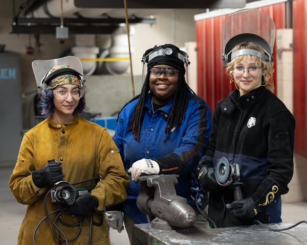 Three women welding students in the lab.