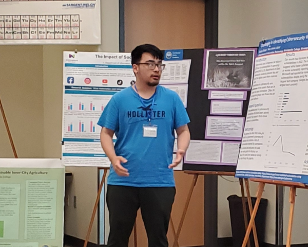Student presents his poster research in a classroom 