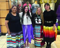Four nursing students stand in front of the College Store