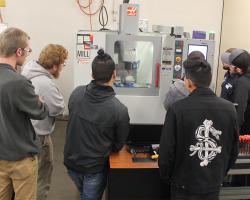 students watching the machine work