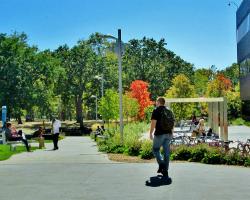 Minneapolis College's Outdoor Plaza Next to Loring Park student walking across the outdoor plaza next to Loring Park