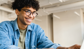 Student working on a laptop in own home