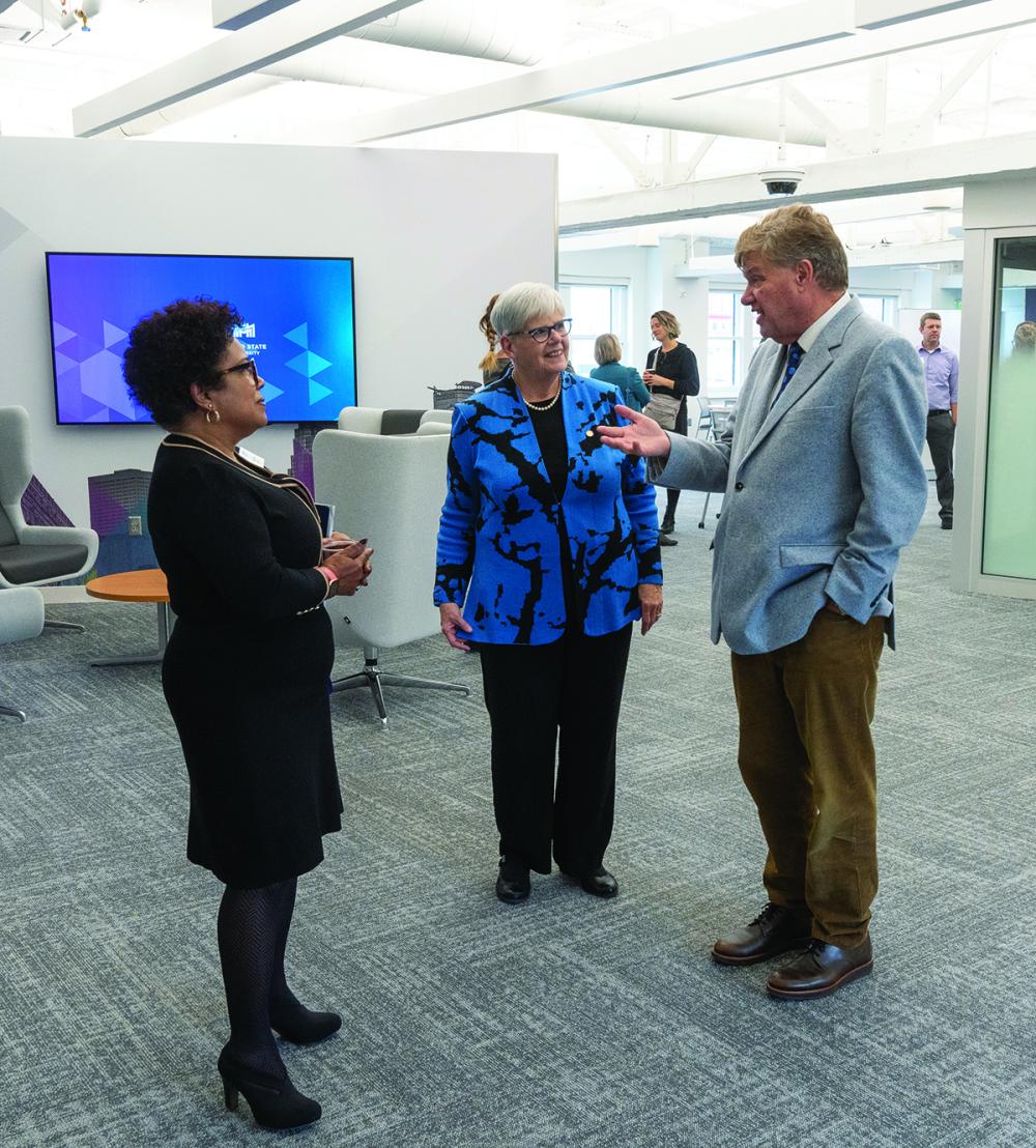 President Pierce and two others stand in the new MEC buiding