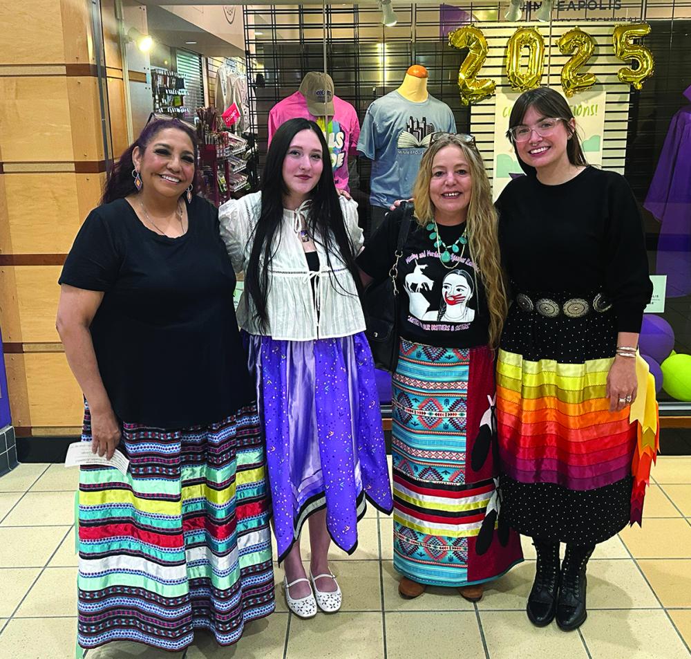 Four nursing students stand in front of the College Store