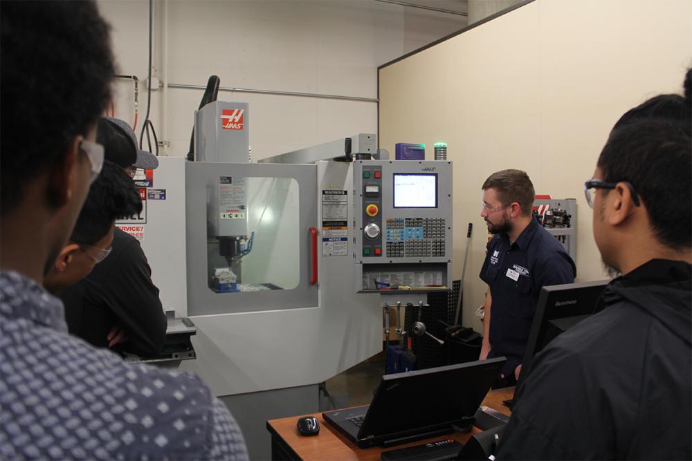 students looking at the machine