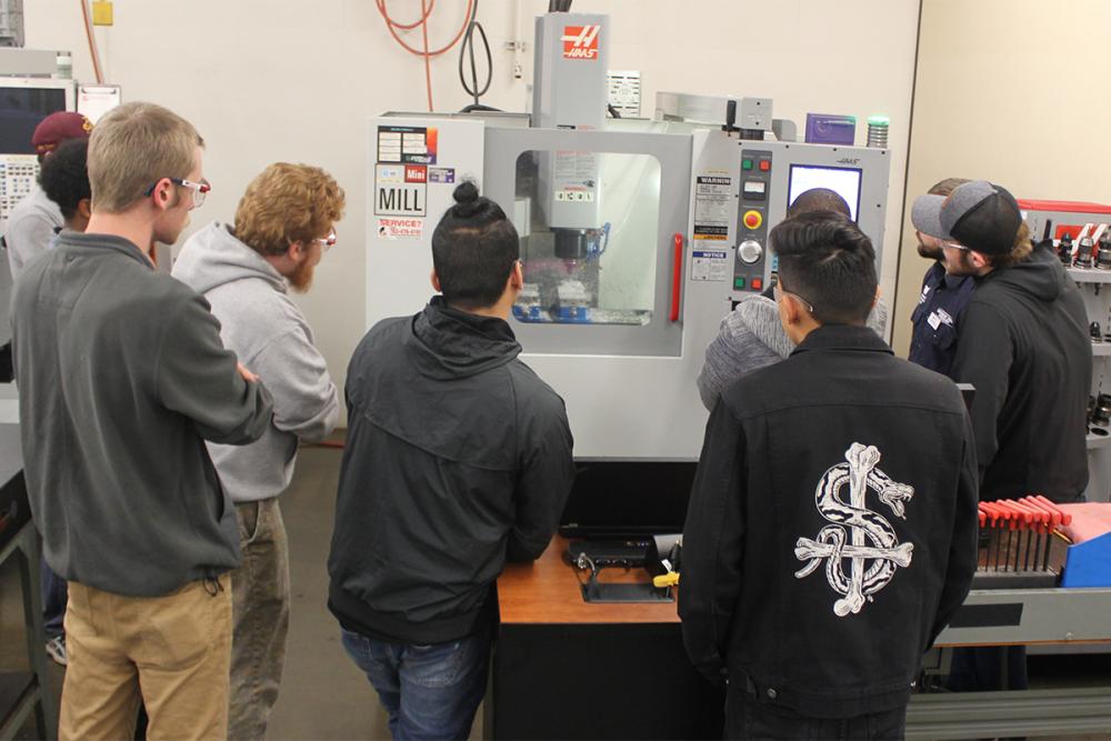 students watching the machine work